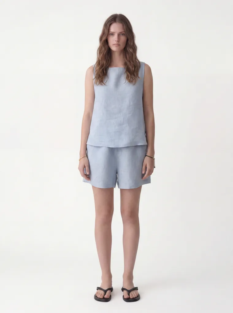 MODA AI catalog output — the linen tank-and-shorts set in powder blue on the same model and background