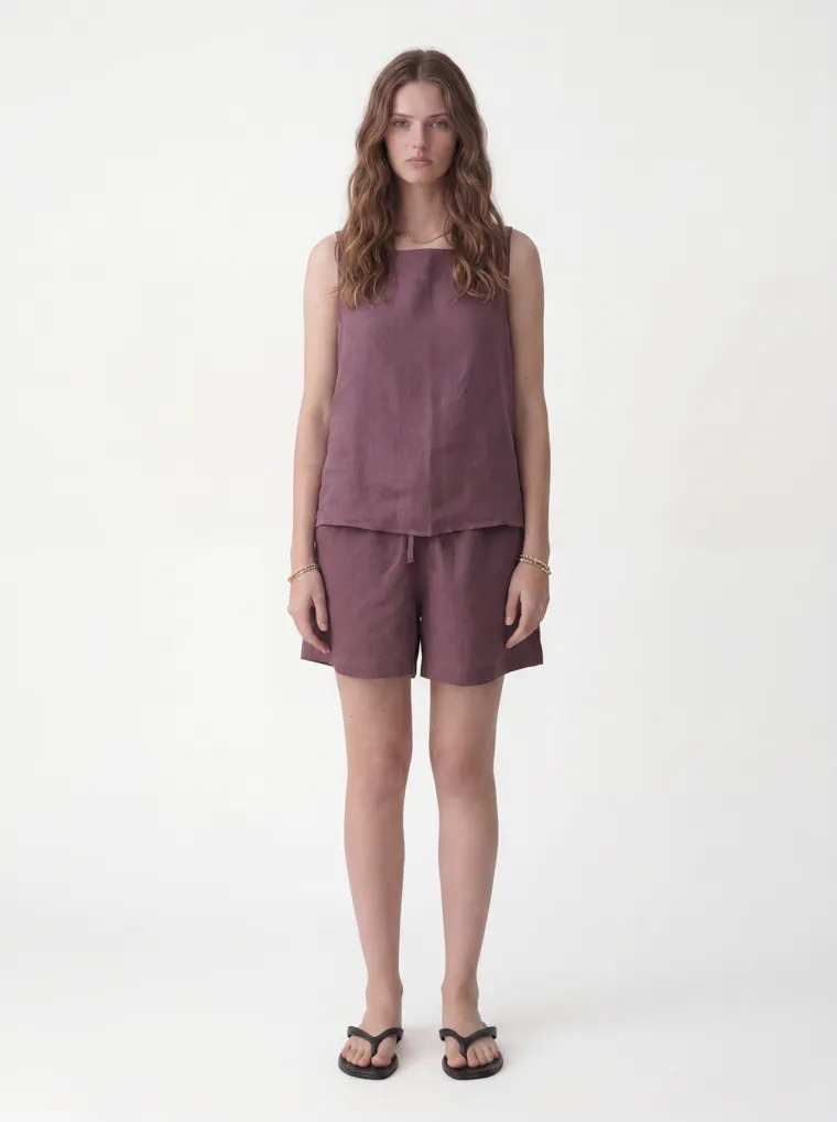 MODA AI catalog output — the linen tank-and-shorts set in plum on the same model and background