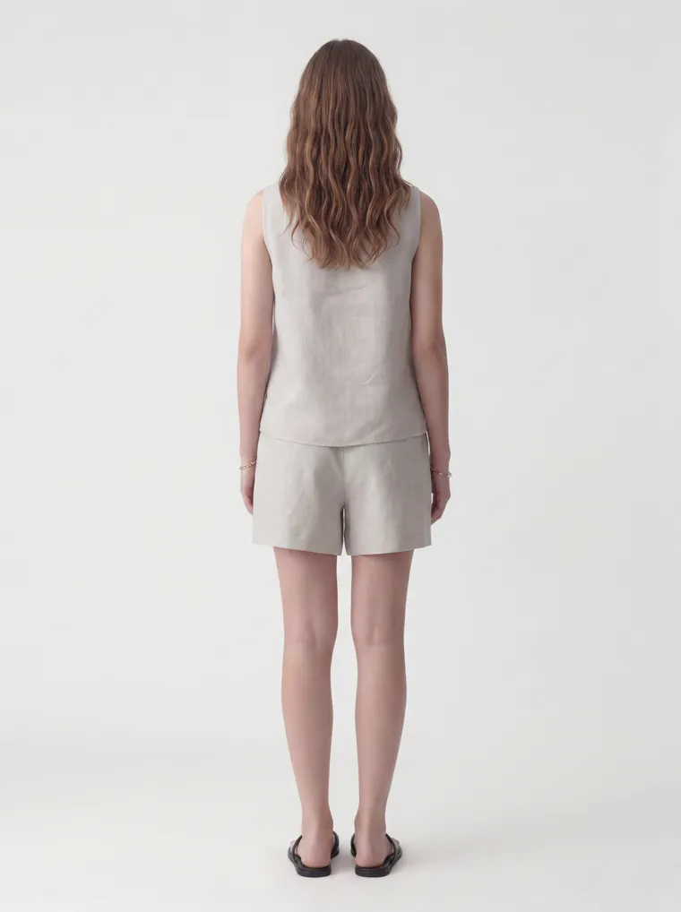 MODA AI catalog output — the linen set in oatmeal, back view, same model and studio