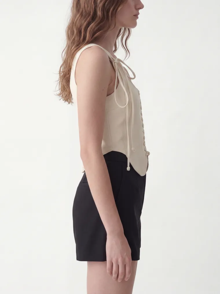 MODA AI catalog output — cream vest top, side detail crop