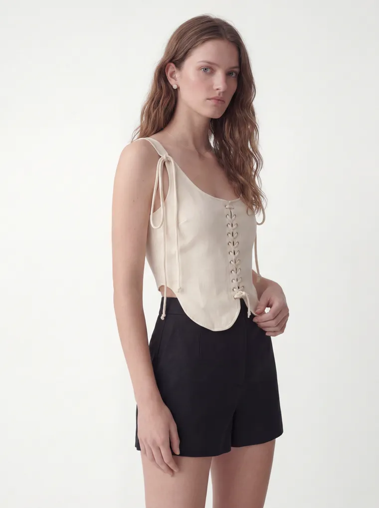 MODA AI catalog output — cream vest top, seated pose