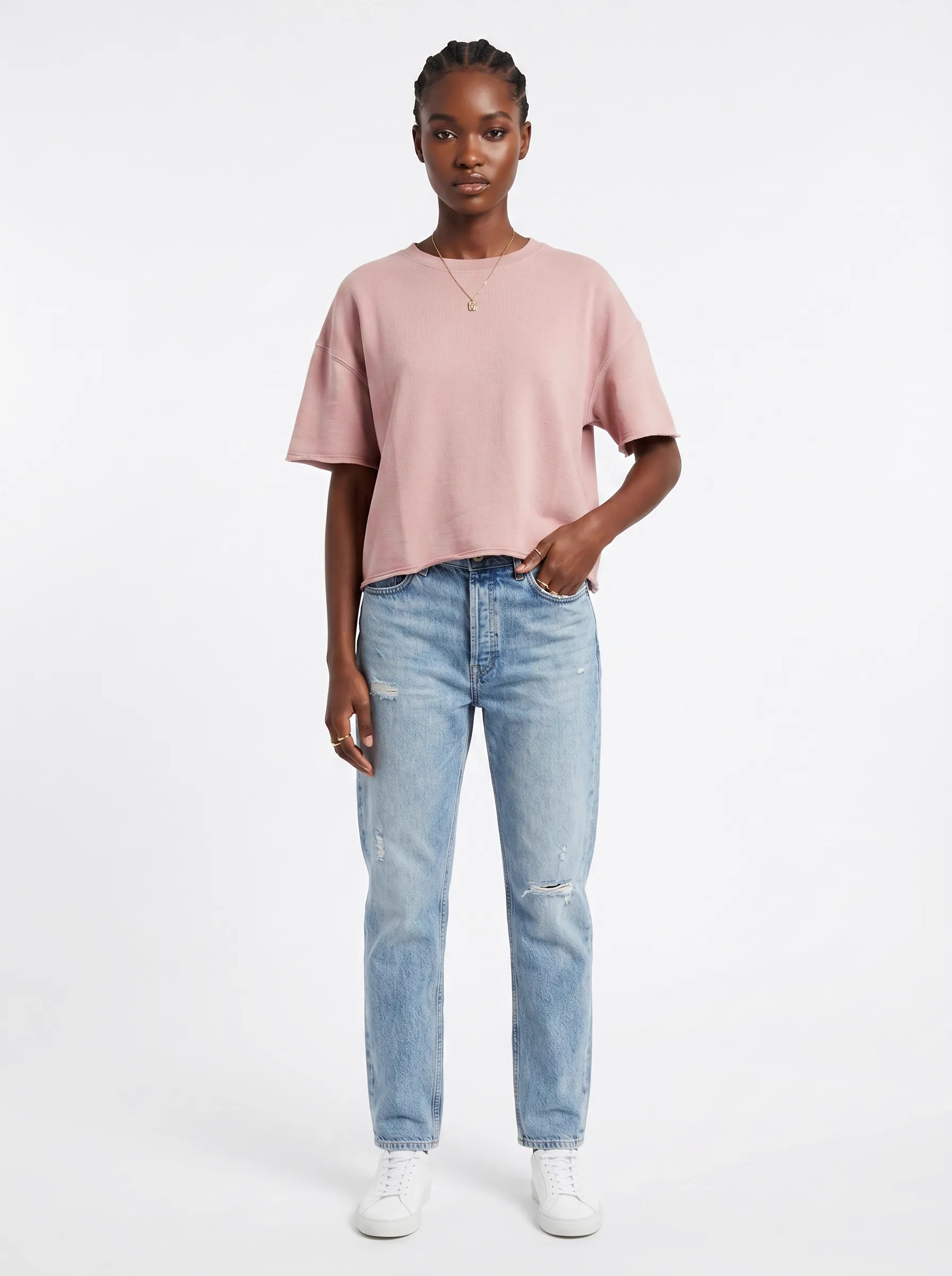 MODA AI catalog output — Black model in pink boxy tee and light-wash blue mom jeans, full body front against clean white studio backdrop
