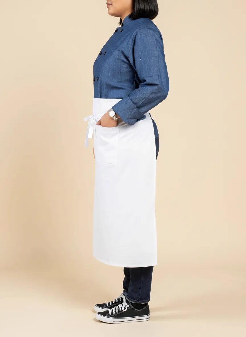 MODA AI output — side profile of plus-size female chef in denim chef coat and white waist apron showing the fit and silhouette of the casual uniform from a profile angle