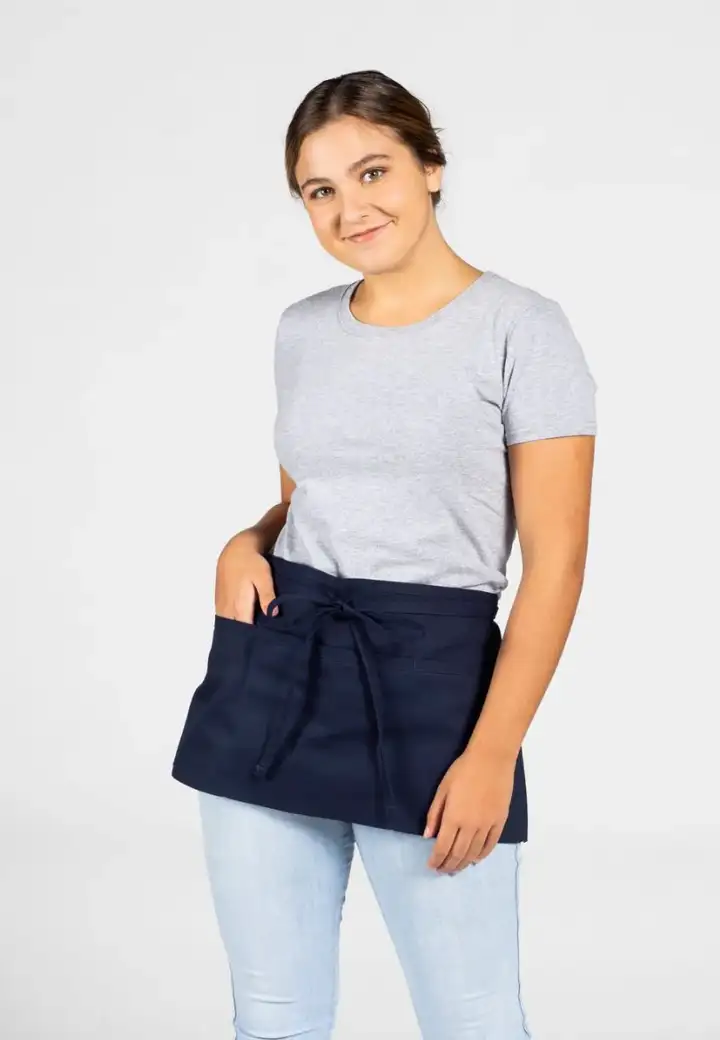Input — female model in short navy waist apron over gray short-sleeve tee with light wash jeans on plain studio background, the original supplier catalog photograph for the server waist apron