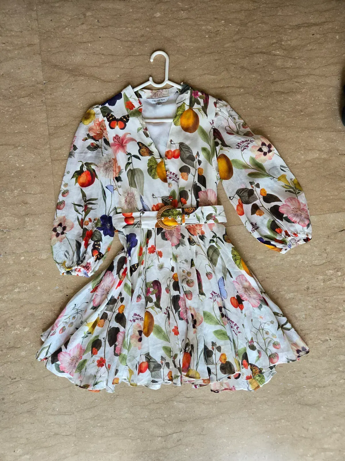 Forever New floral mini dress flat lay — the input photo submitted to both MODA AI and Botika for the head-to-head comparison