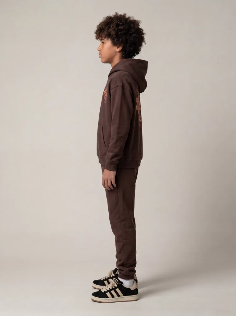 A chocolate brown kids hoodie and jogger set with a tonal animal graphic. FW26 look 20, Tonal Co-ord in Chocolate, frame 4 of 5