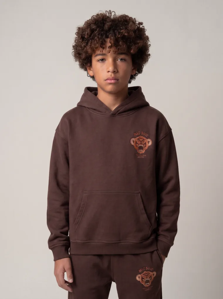 A chocolate brown kids hoodie and jogger set with a tonal animal graphic. FW26 look 20, Tonal Co-ord in Chocolate, frame 5 of 5