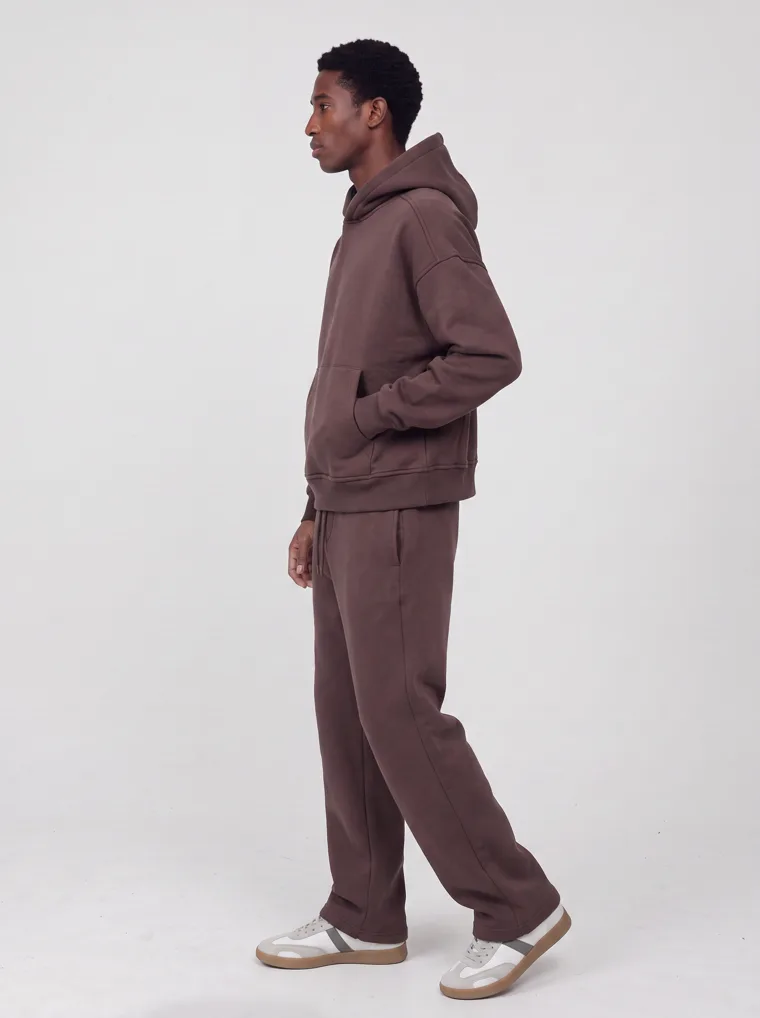 A chocolate brown hooded sweatshirt and matching sweatpants worn as a single tonal set. FW26 look 04, Tonal Set in Chocolate, frame 4 of 5
