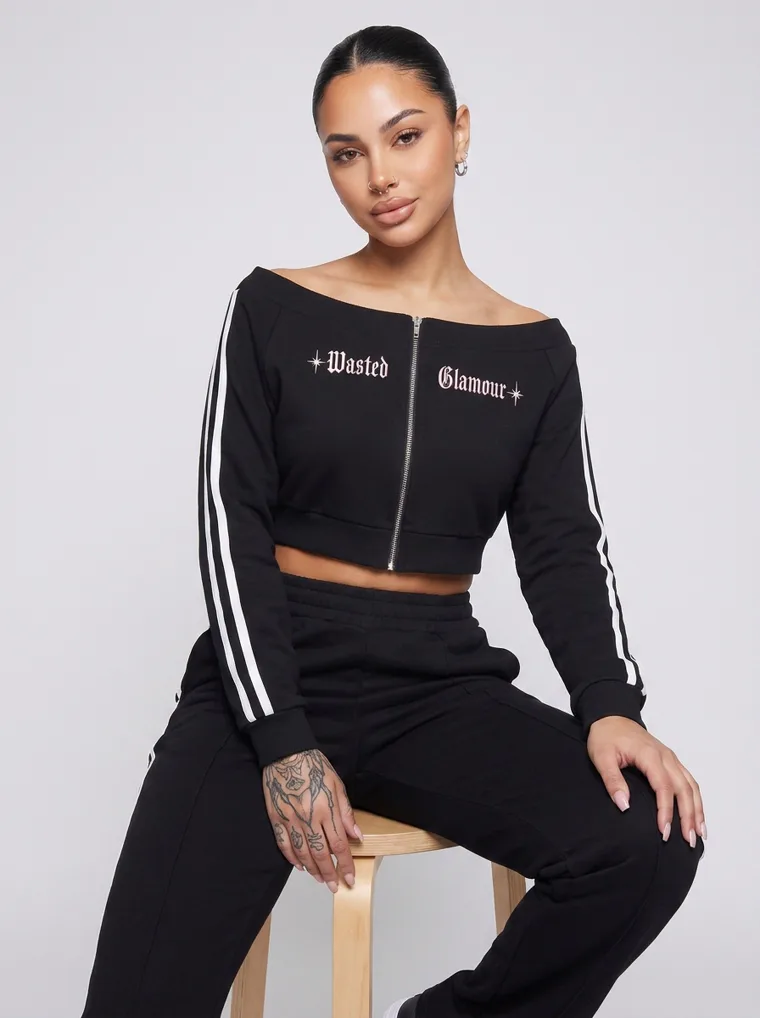 A black cropped zip track top with matching side striped track pants. FW26 look 15, Athletic Monochrome in Black, frame 2 of 5