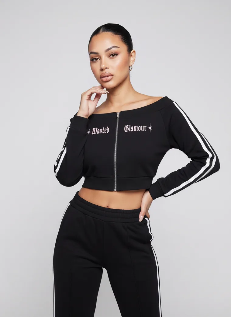 A black cropped zip track top with matching side striped track pants. FW26 look 15, Athletic Monochrome in Black, frame 4 of 5