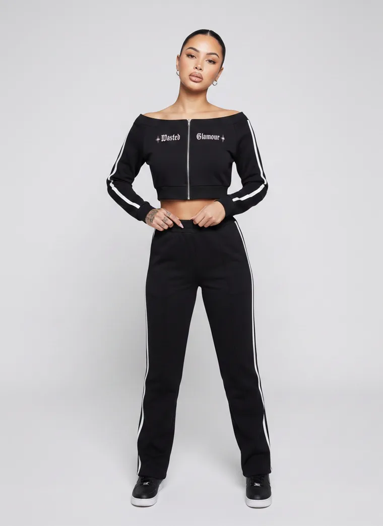A black cropped zip track top with matching side striped track pants. FW26 look 15, Athletic Monochrome in Black, frame 5 of 5