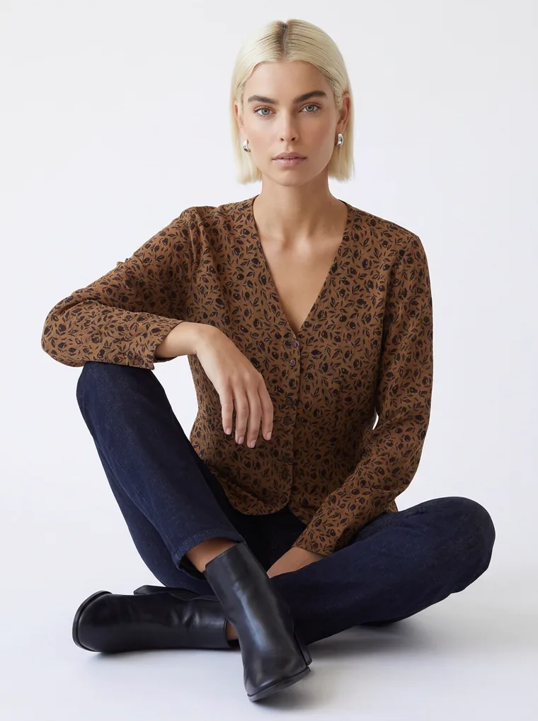 A tobacco brown animal print blouse with dark indigo jeans and black ankle boots. FW26 look 10, Warm Print in Tobacco, frame 2 of 5