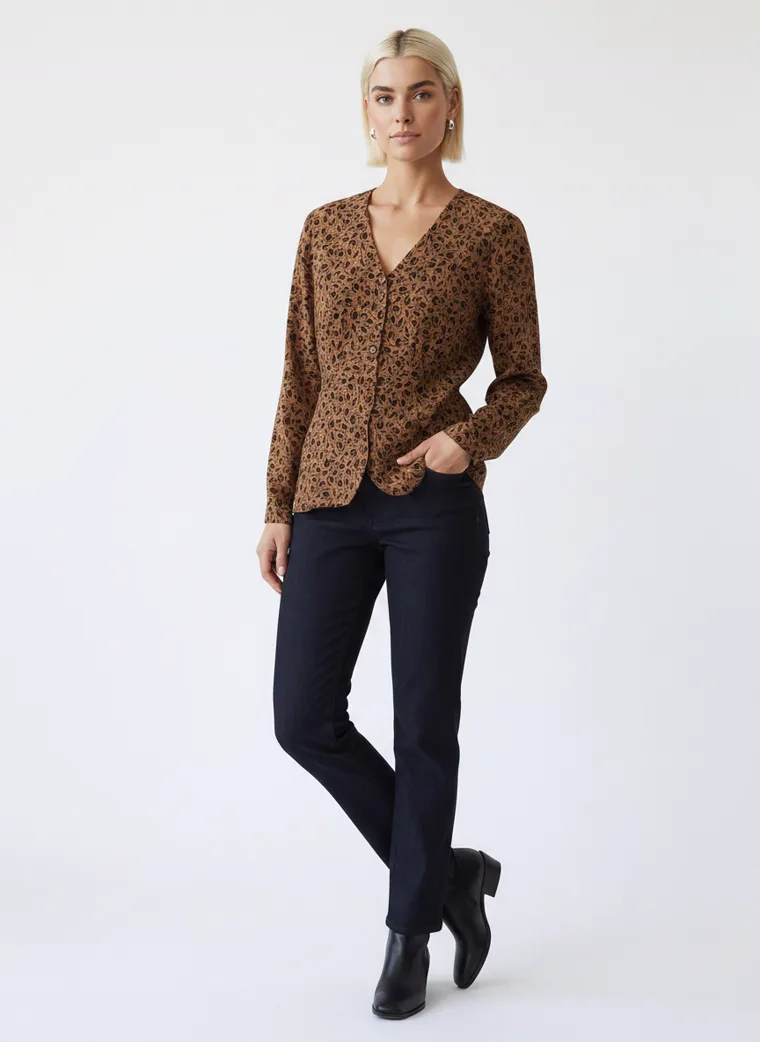 A tobacco brown animal print blouse with dark indigo jeans and black ankle boots. FW26 look 10, Warm Print in Tobacco, frame 3 of 5