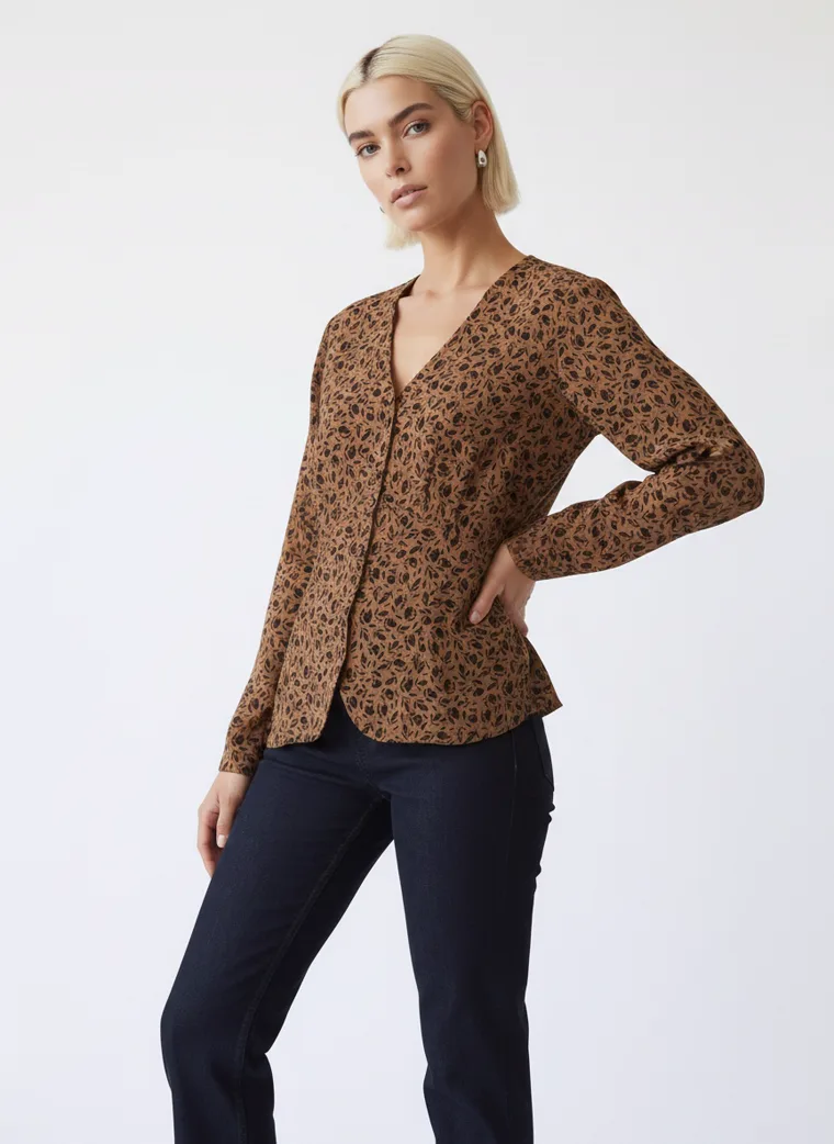 A tobacco brown animal print blouse with dark indigo jeans and black ankle boots. FW26 look 10, Warm Print in Tobacco, frame 4 of 5