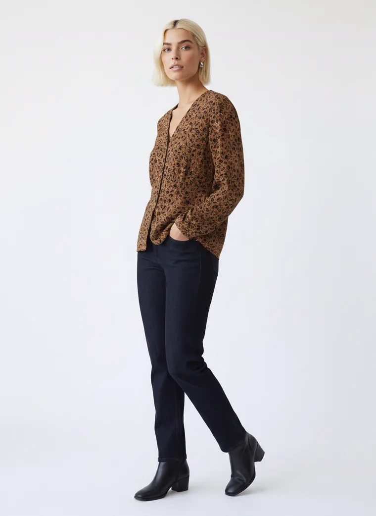 A tobacco brown animal print blouse with dark indigo jeans and black ankle boots. FW26 look 10, Warm Print in Tobacco, frame 5 of 5
