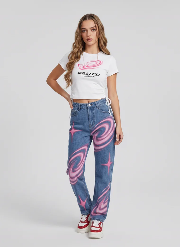 A white cropped tee with blue jeans printed in pink swirl and star graphics. FW26 look 13, Statement Surface in Denim, frame 4 of 5
