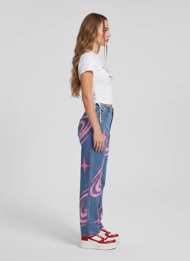 A white cropped tee with blue jeans printed in pink swirl and star graphics. FW26 look 13, Statement Surface in Denim, frame 5 of 5