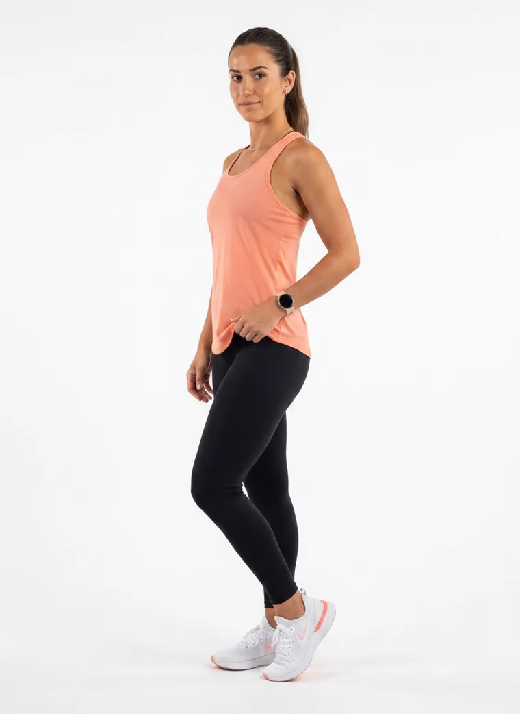 A peach racerback vest with full length black leggings. FW26 look 17, Soft Sport in Peach, frame 4 of 5
