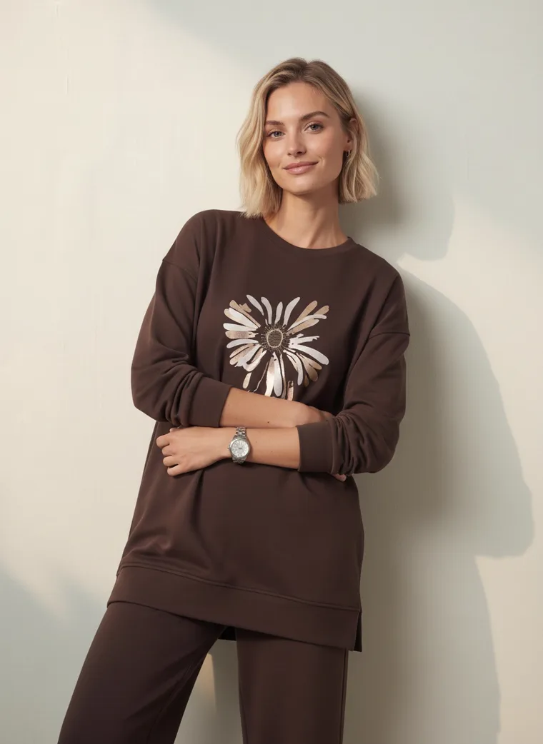 A chocolate brown sweatshirt with a cream daisy graphic and matching wide leg lounge trousers. FW26 look 12