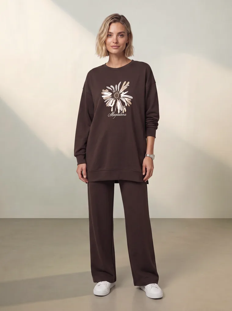 A chocolate brown sweatshirt with a cream daisy graphic and matching wide leg lounge trousers. FW26 look 12, Tonal Lounge in Chocolate, frame 2 of 5