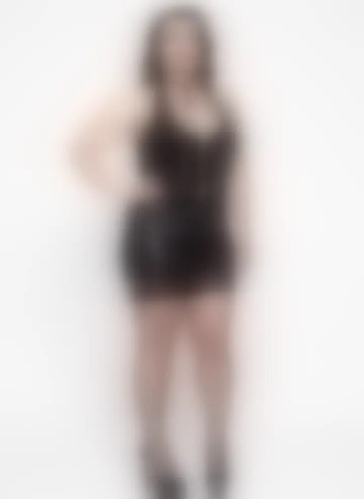 Blurred still from a ten second video of the corset and wet-look skirt set