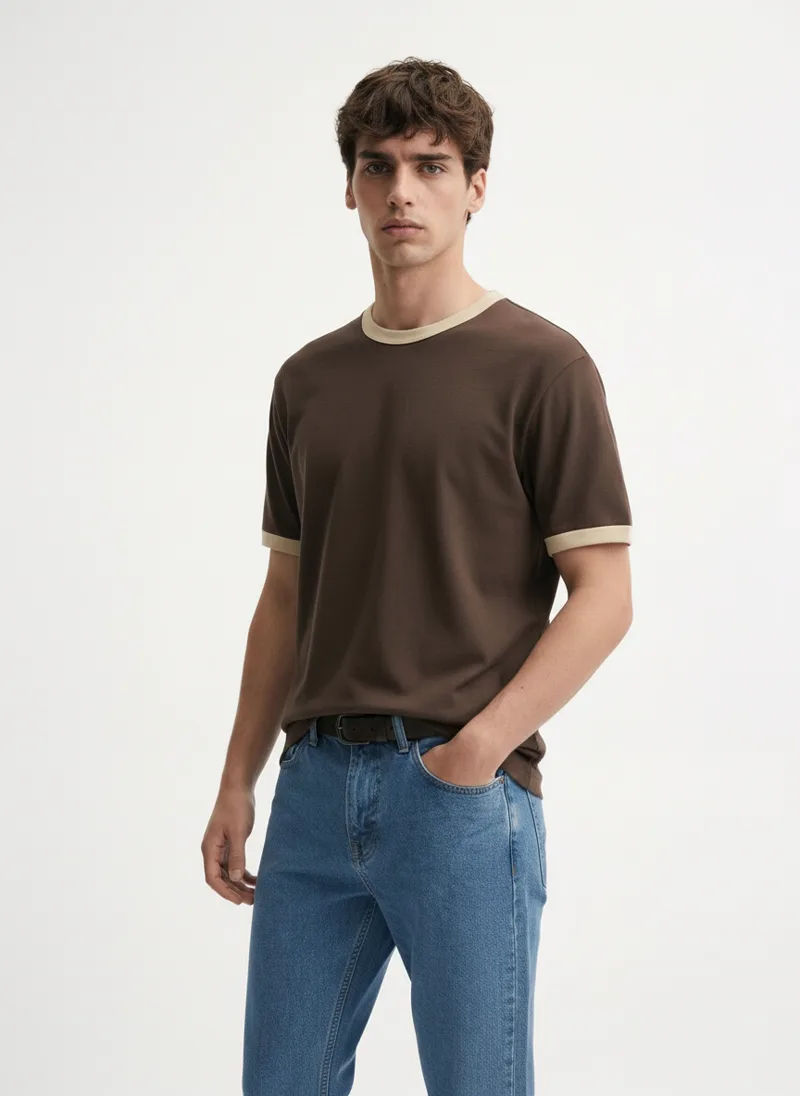MODA AI output — model in the brown tee and belted jeans, back view, belt visible