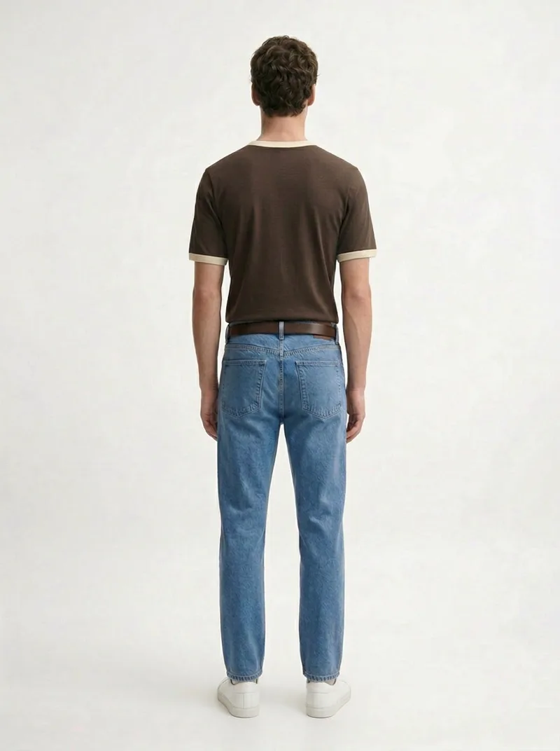 MODA AI output — model in the brown tee and belted jeans, three-quarter, tee tucked in