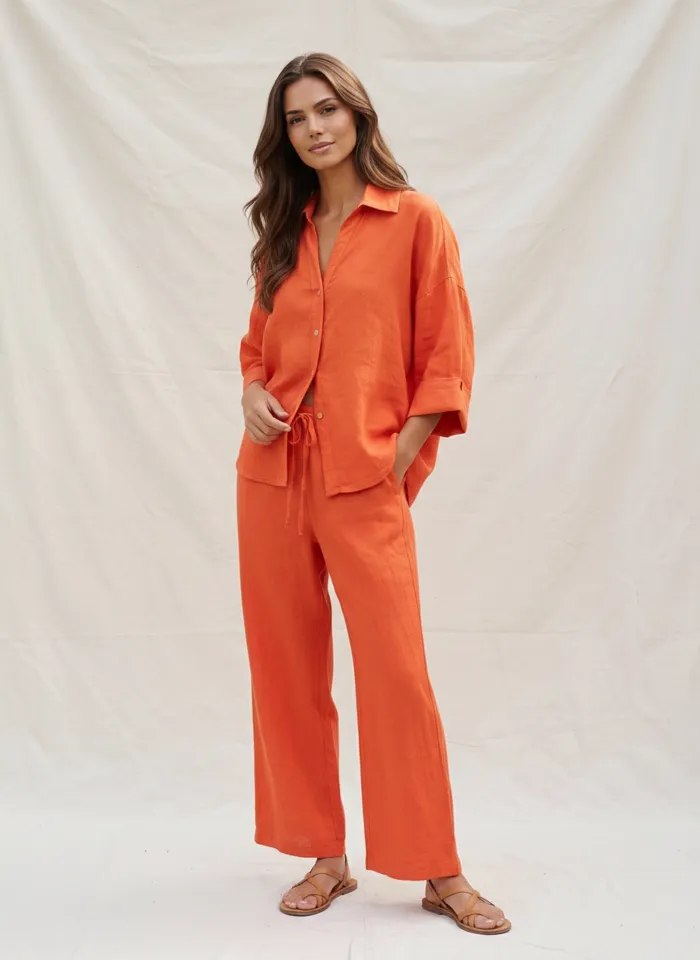 MODA AI on-model output — the orange cropped shirt and wide-leg trousers, another angle