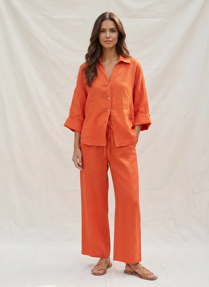 MODA AI on-model output — the orange linen set, lifestyle angle