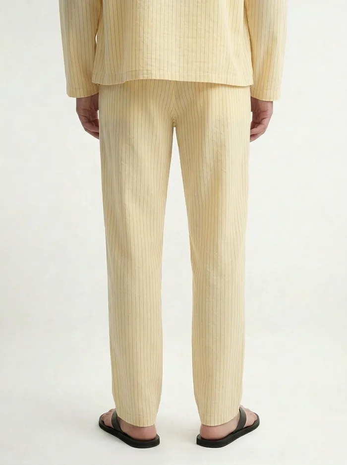MODA AI on-model output — the yellow overshirt and trousers, lifestyle angle