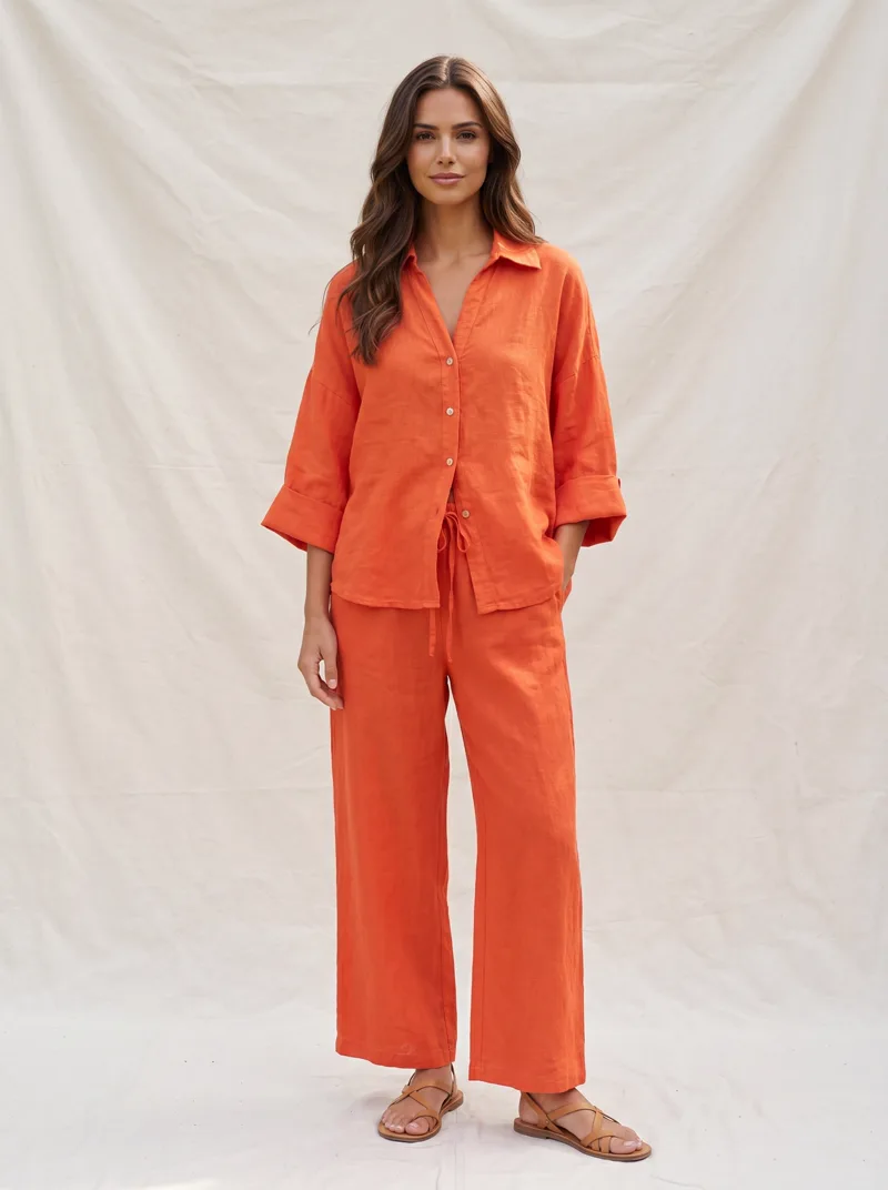MODA AI output — model wearing the orange shirt and trousers together, front full length