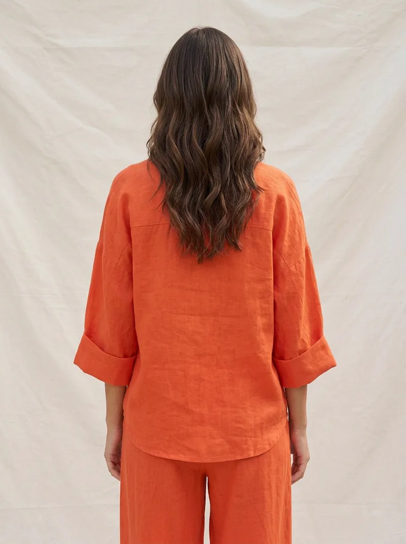 MODA AI output — model in the orange set, back view