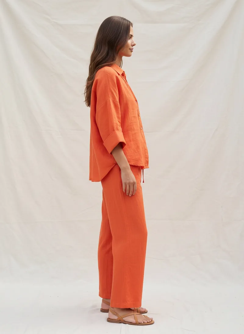 MODA AI output — model in the orange set, side profile