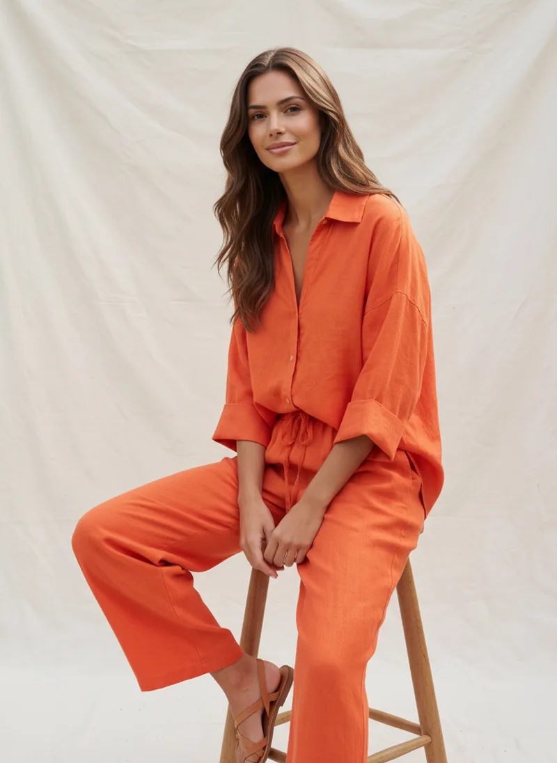 MODA AI output — model seated in the orange coordinated set