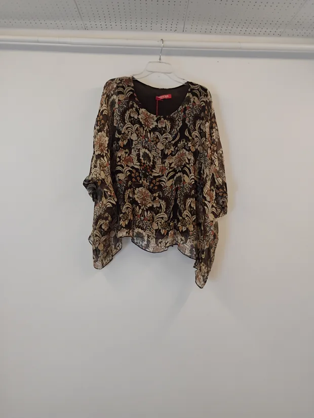 Hanger shot input — a brown paisley print kaftan-style top with fluted sleeves, hanging against a plain shop wall