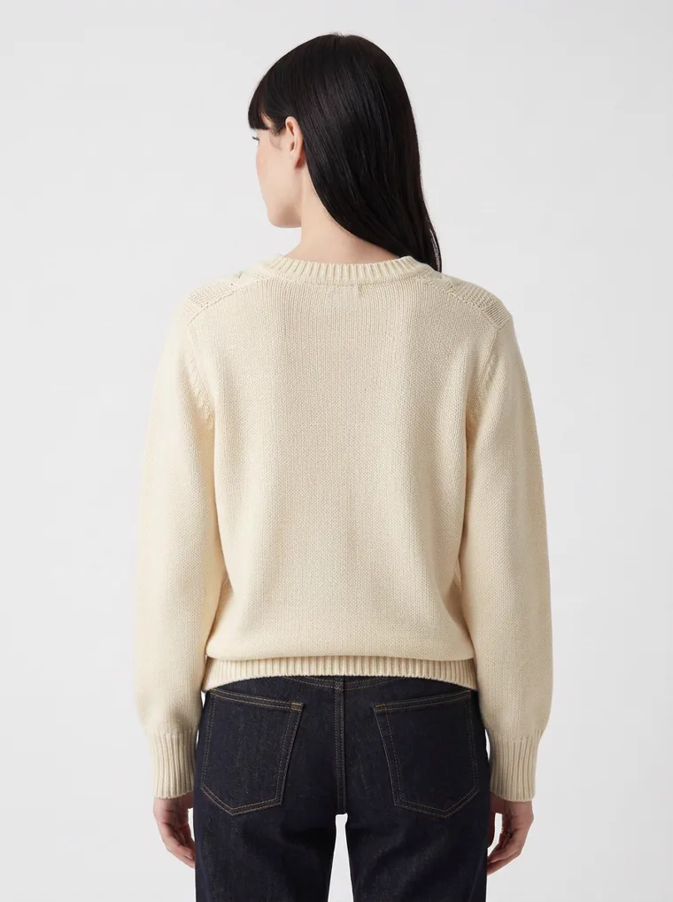 MODA AI output — the cable-knit jumper from behind, showing the plain knit back and ribbed hem