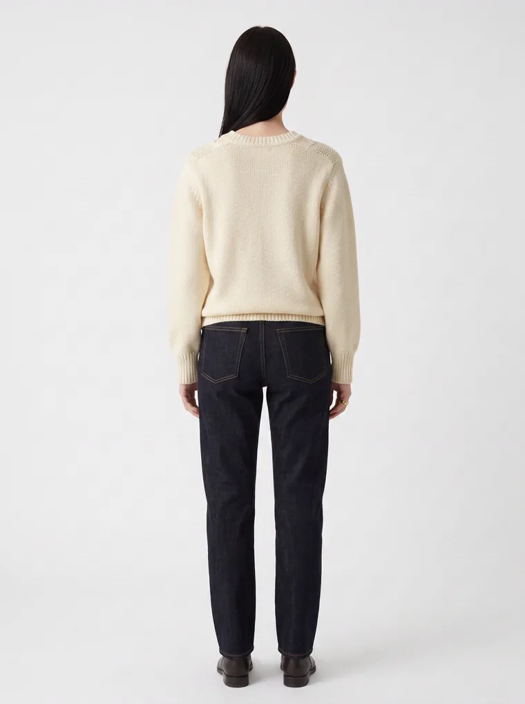MODA AI output — the cable-knit jumper, full-length back view with dark jeans and boots
