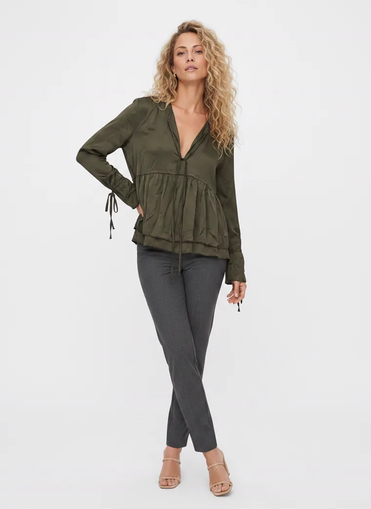 MODA AI output — the olive tiered blouse on the model, angled pose showing the tie cuff detail and the drape of the sleeve