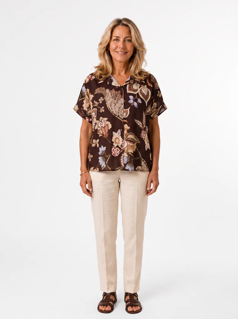 MODA AI output — a woman wearing the brown floral short-sleeve blouse with cream trousers and sandals