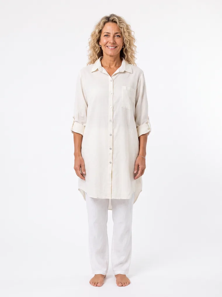 MODA AI output — a woman wearing the cream shirt dress over white trousers in a clean studio