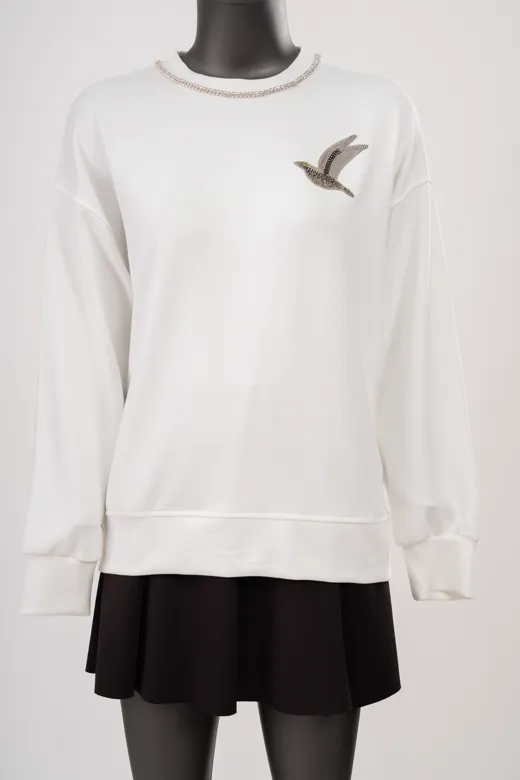 The starting photo for the white and black embroidered crew sweatshirt: the sweatshirt and skirt on a mannequin