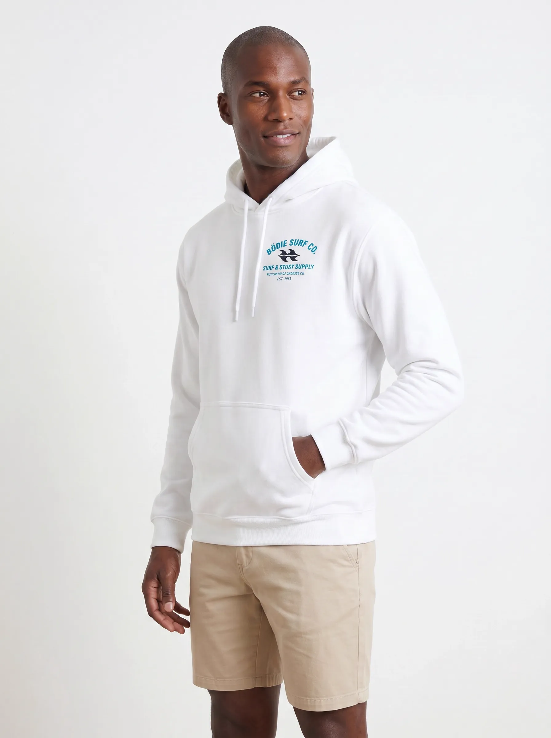 MODA AI output 3 — Black male model in white Bödie Surf Co hoodie, chest logo legible, demonstrating logo reproduction and skin tone realism