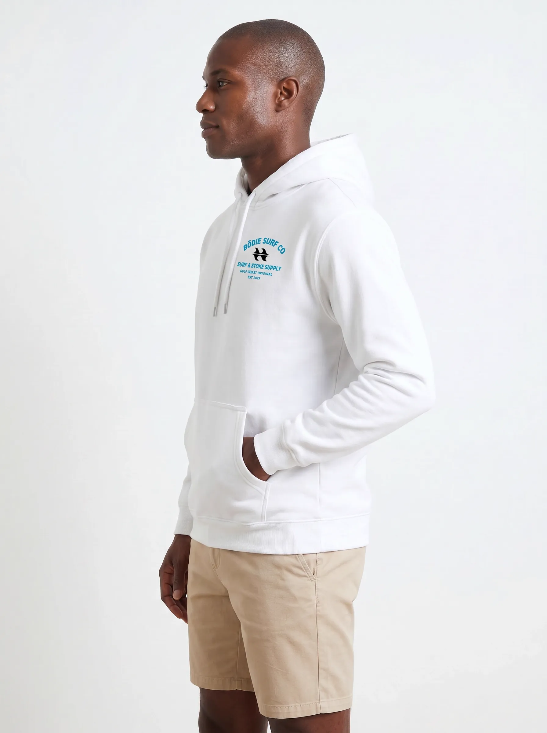 MODA AI output 6 — Black male model in white Bödie Surf Co hoodie, chest logo legible, demonstrating logo reproduction and skin tone realism