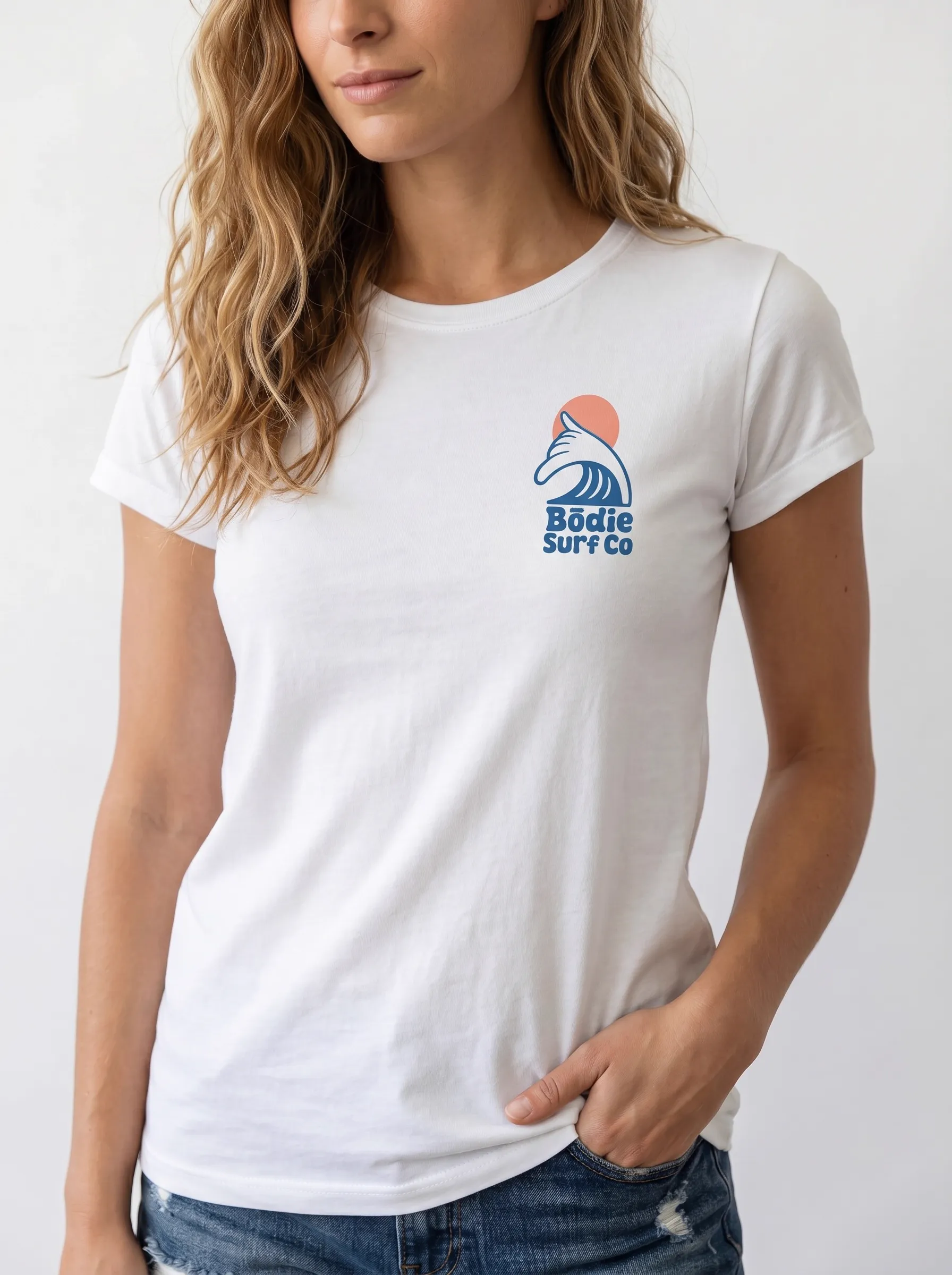 MODA AI output 5 — brunette female model in white Bödie Surf Co tee, locked by face reference, chest wave logo consistent across catalog angle