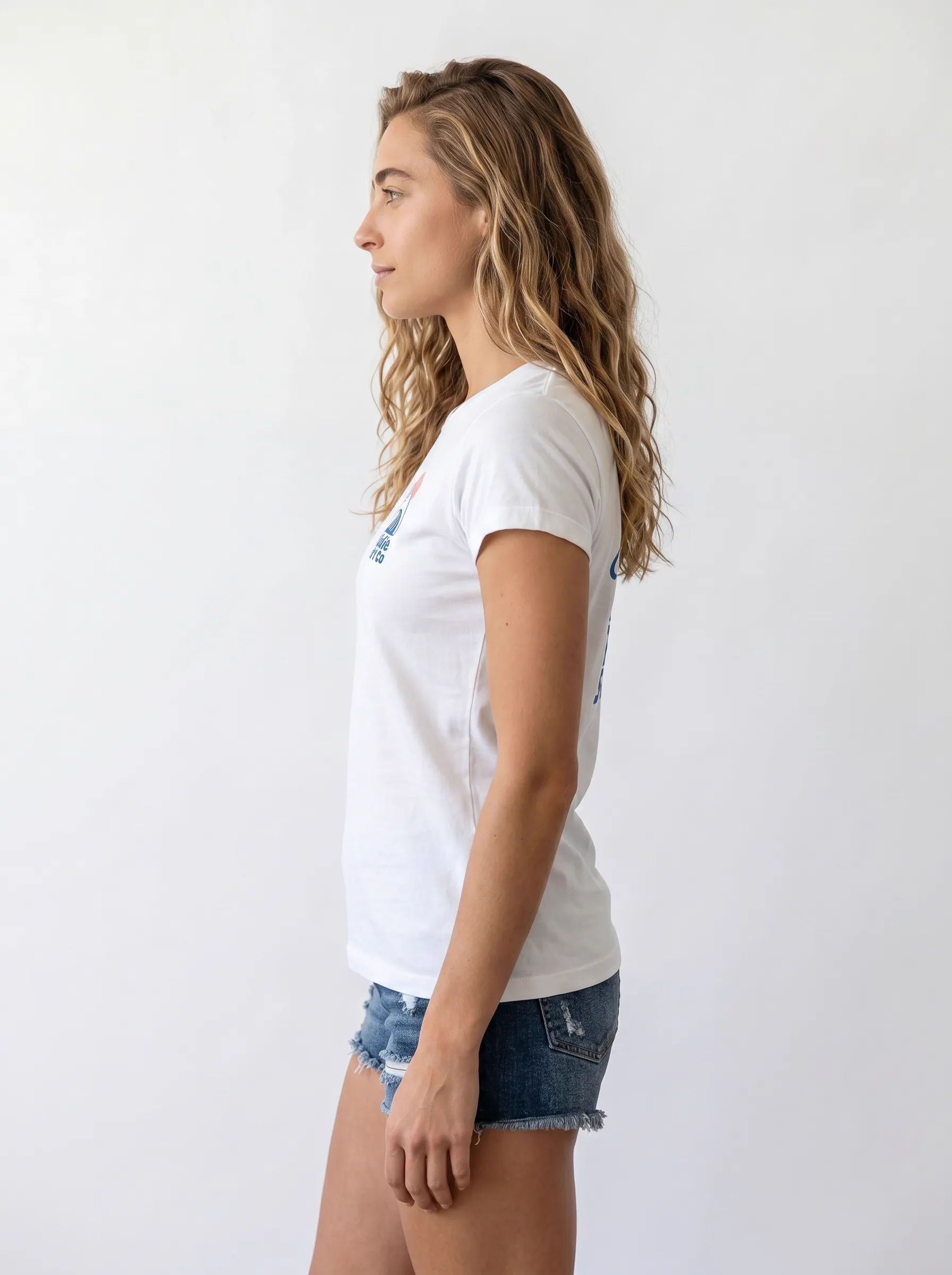 MODA AI output 6 — brunette female model in white Bödie Surf Co tee, locked by face reference, chest wave logo consistent across catalog angle