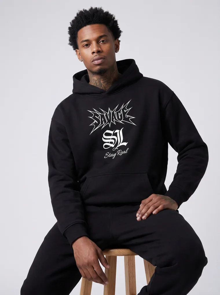A black hoodie and sweatpants with a gothic chest print and a large matching back print. Graphic Hoodie Set in Black, frame 1 of 5