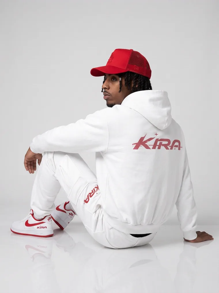 A white zip hoodie and cargo sweatpants with a red logo, red cap and red trimmed sneakers on light grey. Zip Hoodie Set in White, frame 4 of 5
