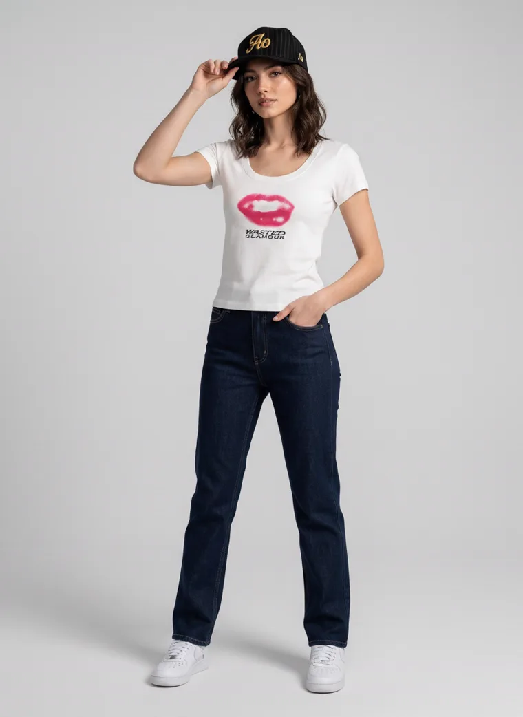A fitted white tee with a pink lips graphic on the front and a rose print with lettering on the back, worn with dark indigo jeans and a black cap. Graphic Tee in White, frame 5 of 5