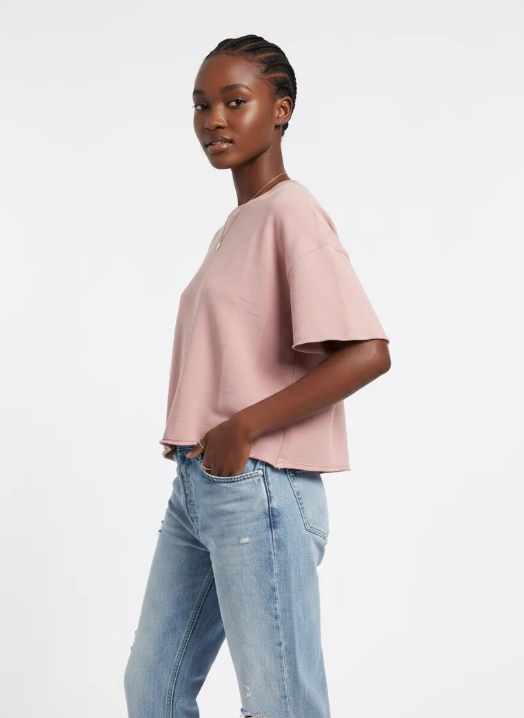 A blush boxy tee with light wash straight jeans and white sneakers on pale grey. Boxy Tee in Blush, frame 2 of 5