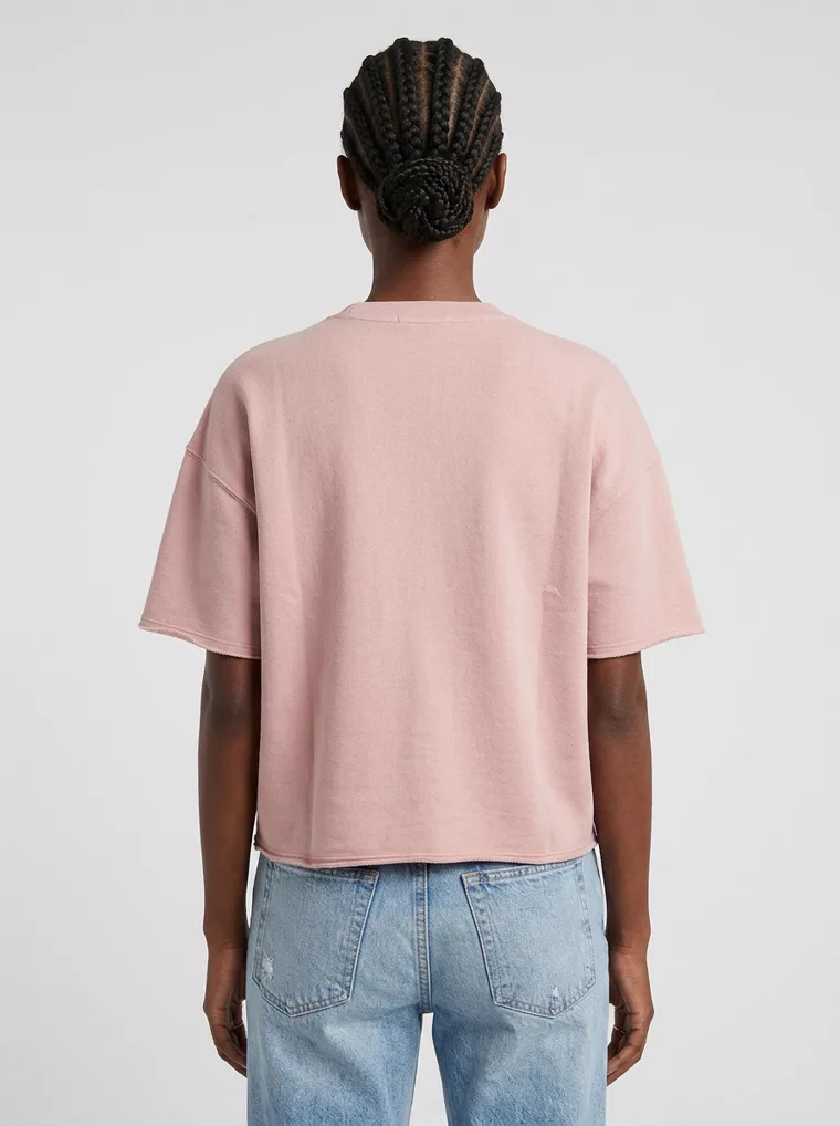 A blush boxy tee with light wash straight jeans and white sneakers on pale grey. Boxy Tee in Blush, frame 4 of 5